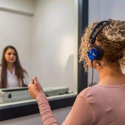 An audiologist performing a hearing test on a patient.
