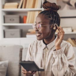 Young woman showing off her hearing aid