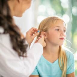Young girl gets hearing aid