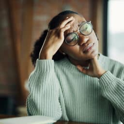 Stressed woman sitting at a table looking worried
